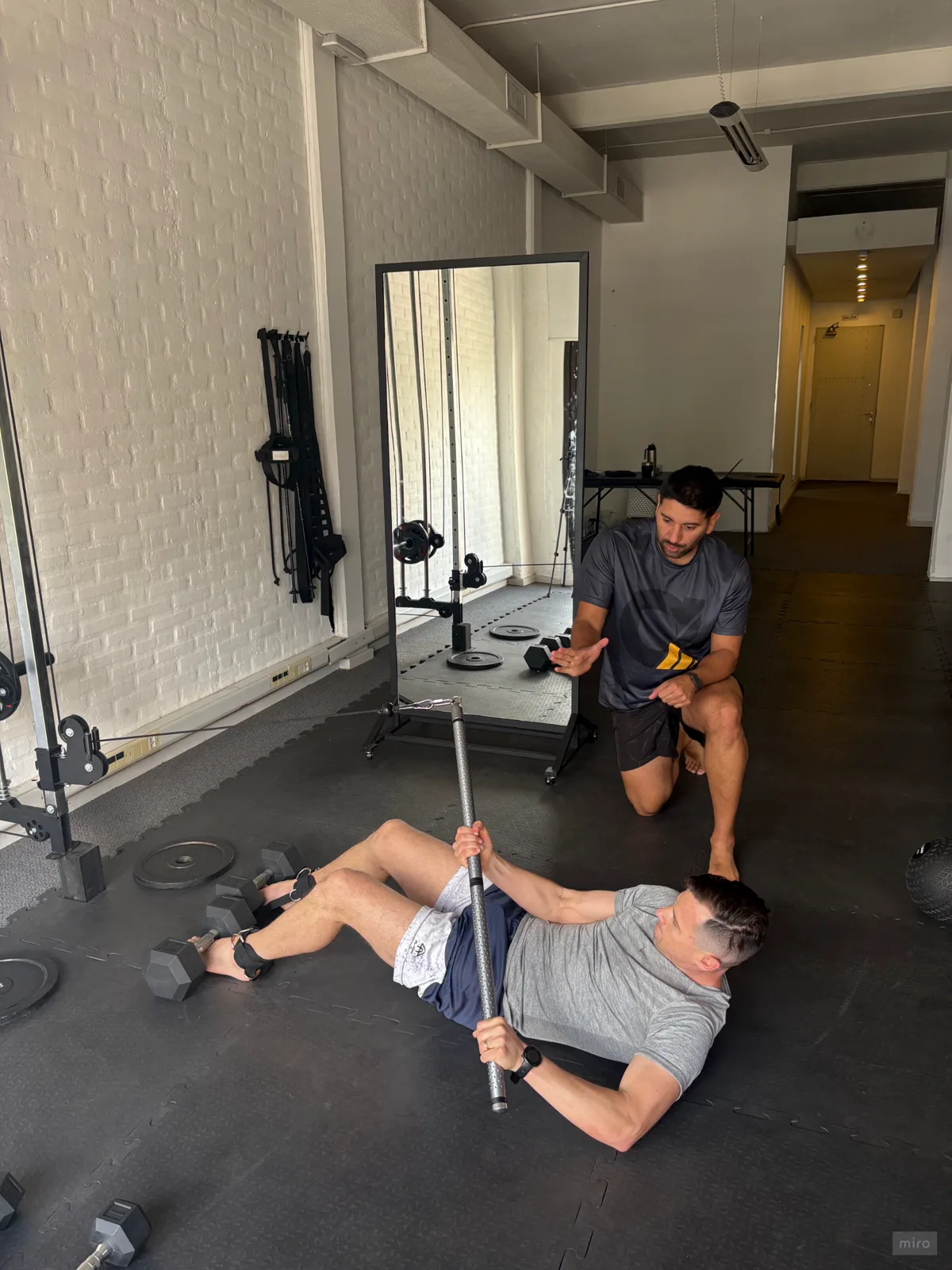 Coach corrigiendo un ejercicio en una sesión 1 a 1